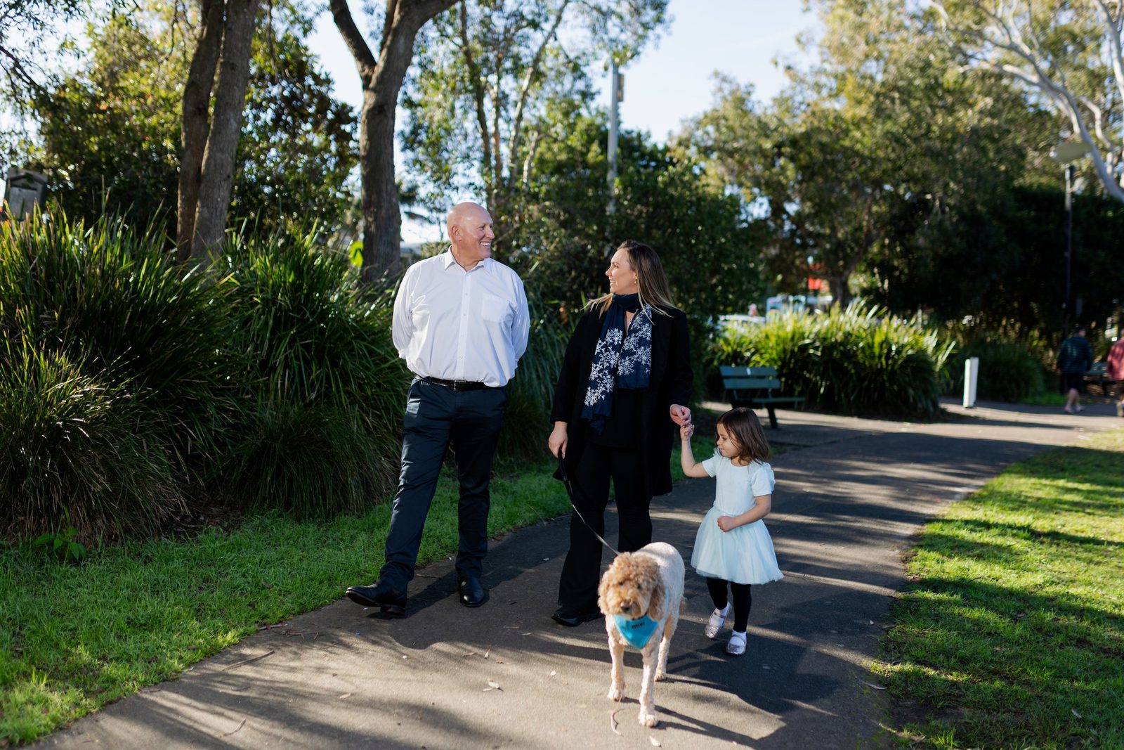 Michael Gencher walking with a family on a local path